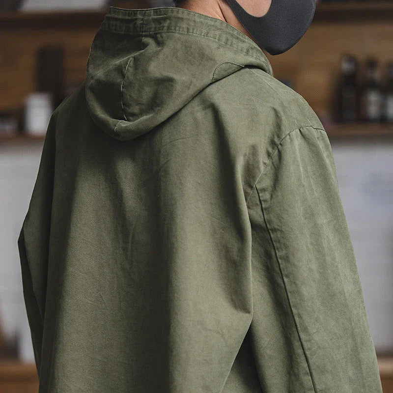 Rugged military-style windbreaker jacket for men, featuring a hooded design, cotton construction, and a classic, streamlined silhouette.