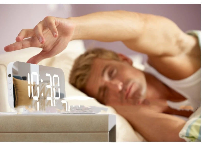 Digital mirror clock with LED display and dual USB ports on a desk