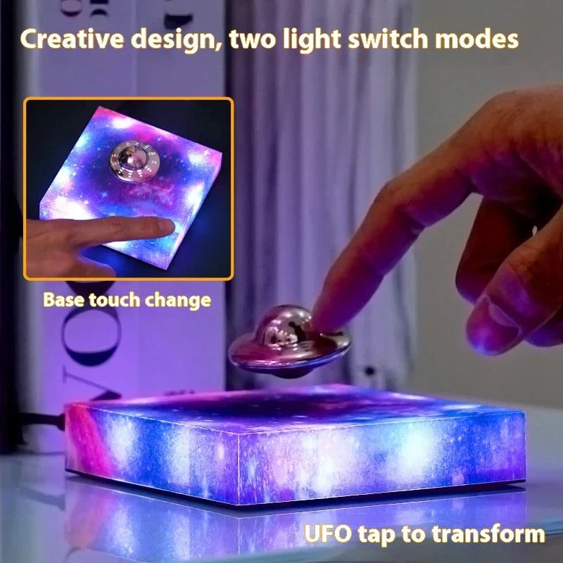 Futuristic levitating UFO lamp with color-changing lights and Milky Way galaxy base