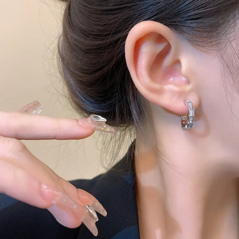 Elegant sterling silver drop earrings featuring sparkling zircon gemstones in a modern geometric design