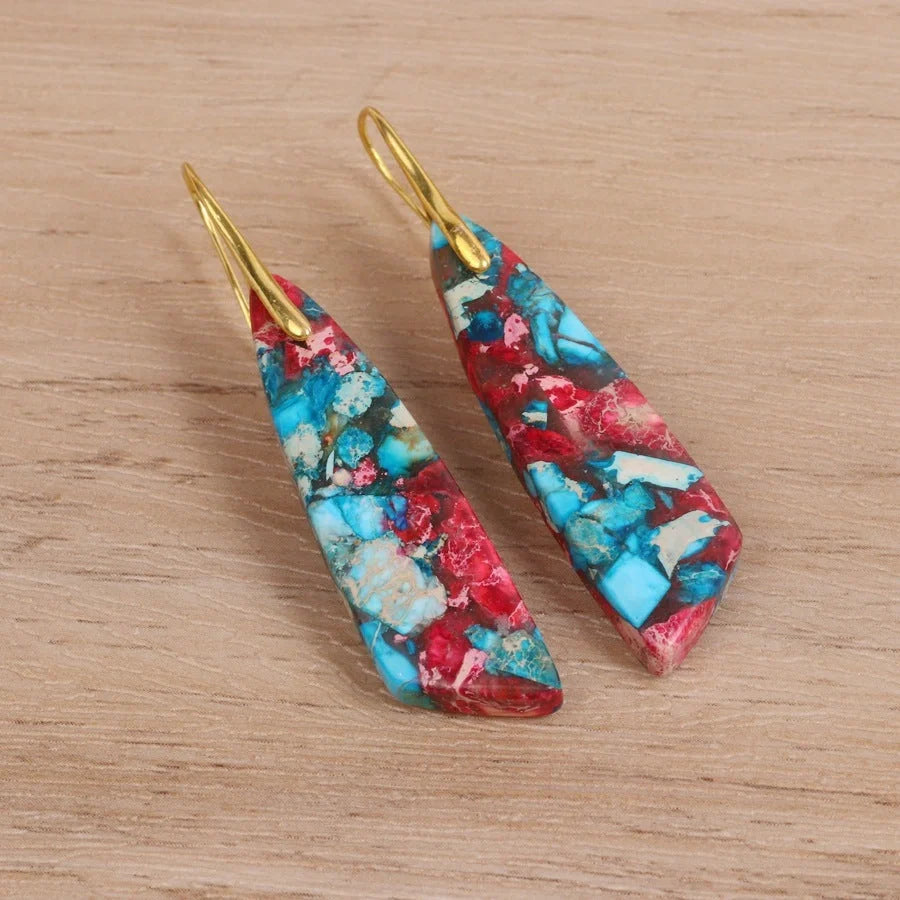 Geometric flower shape pendant earrings in copper with gold hooks, available in red, green, and blue.