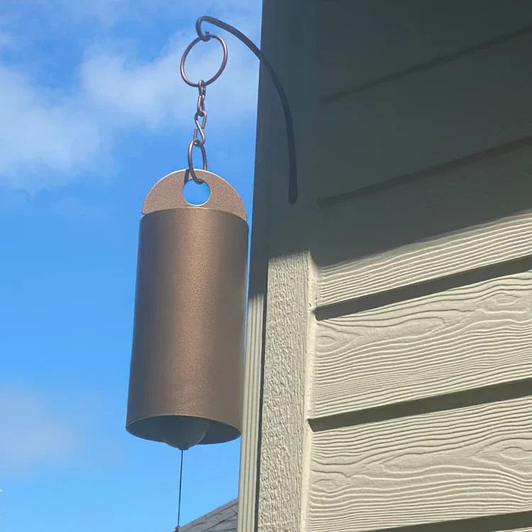 Handcrafted metal wind chimes in black and brown colors, available in small and large sizes, creating a serene outdoor ambiance