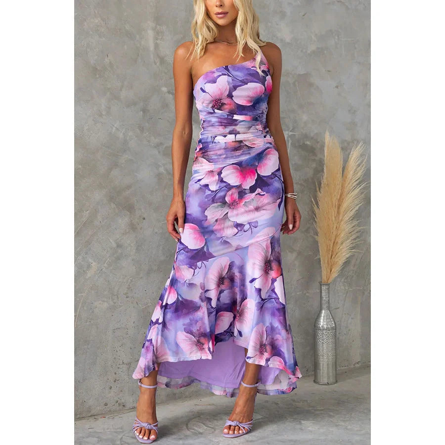 Floral one-shoulder dress in various colours, featuring a unique design and comfortable polyester fabric for effortless summer style.