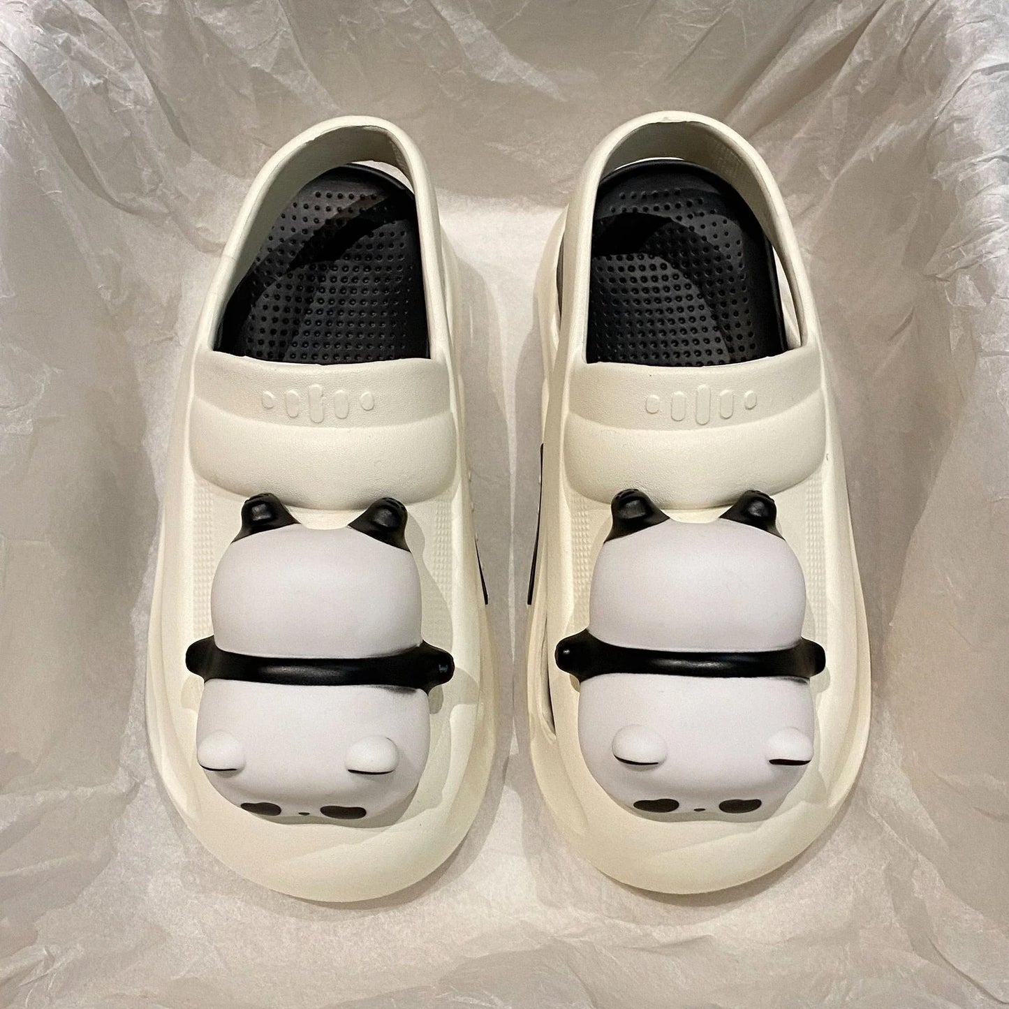 Adorable panda-themed slip-on slippers in various colors and sizes, featuring a lightweight and breathable design for comfortable everyday wear.
