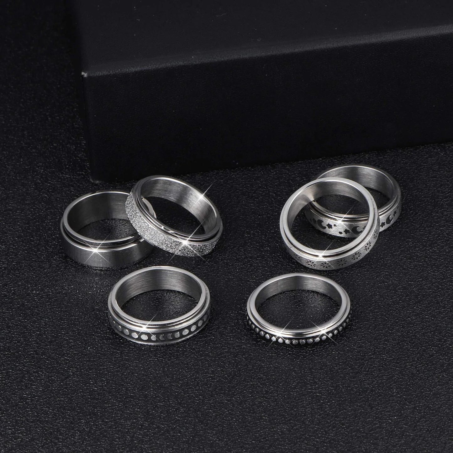 Elegant stainless steel spinner ring with a captivating moon and star design that rotates effortlessly for a calming tactile experience