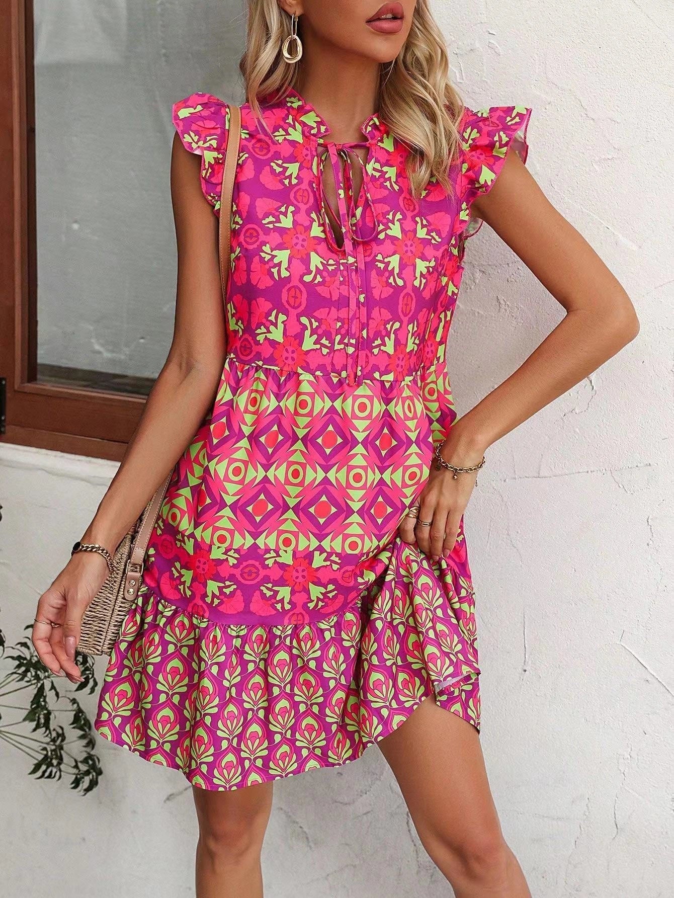 Stylish sleeveless dress with v-neck, lace-up detailing, and vibrant digital printing for a chic summer look