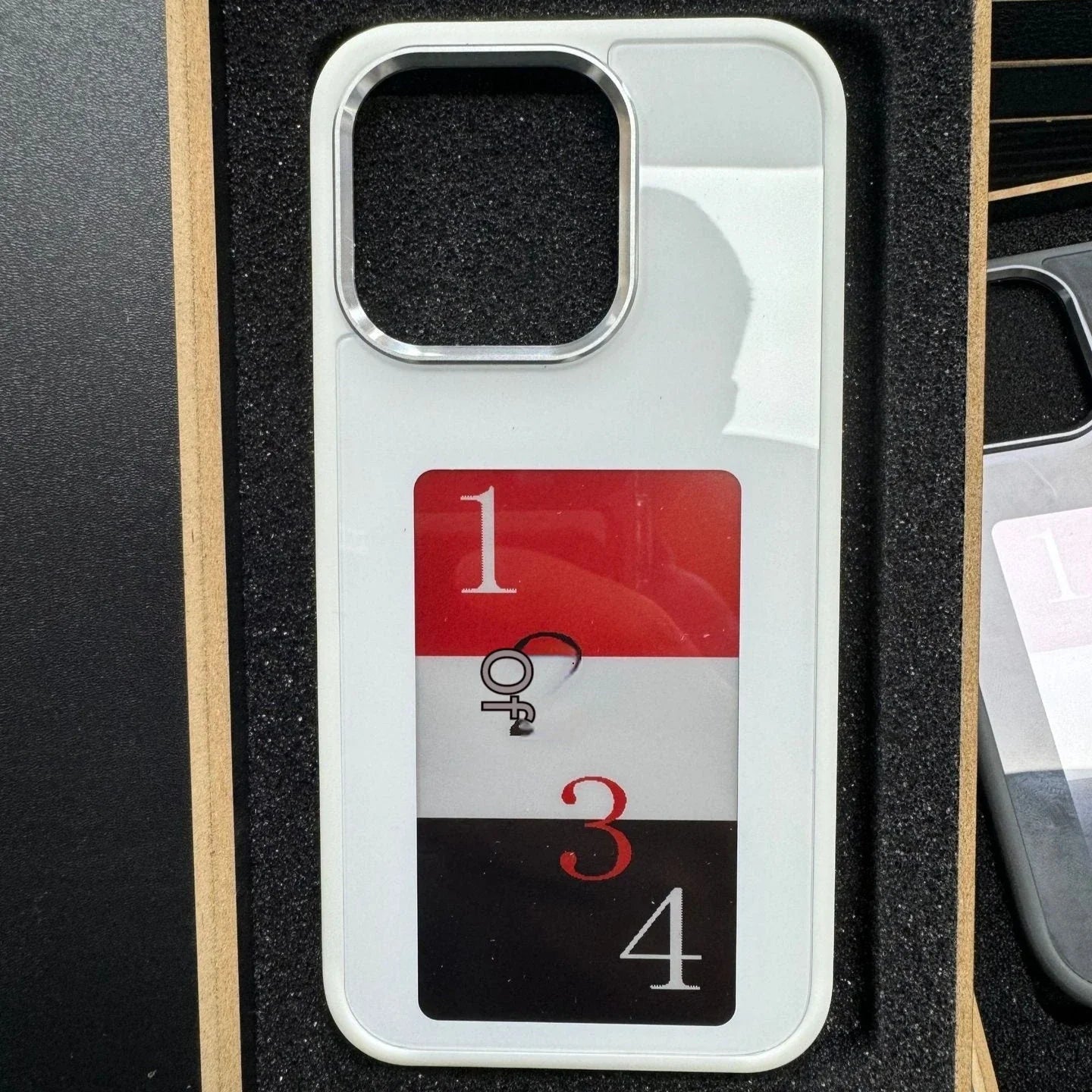 A customizable phone case with an e-ink display that allows users to wirelessly project their preferred images.
