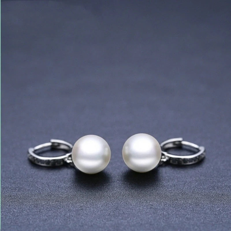 Trendy copper ball stud earrings with a minimalist design, showcasing a sleek and modern accessory for fashion-forward women