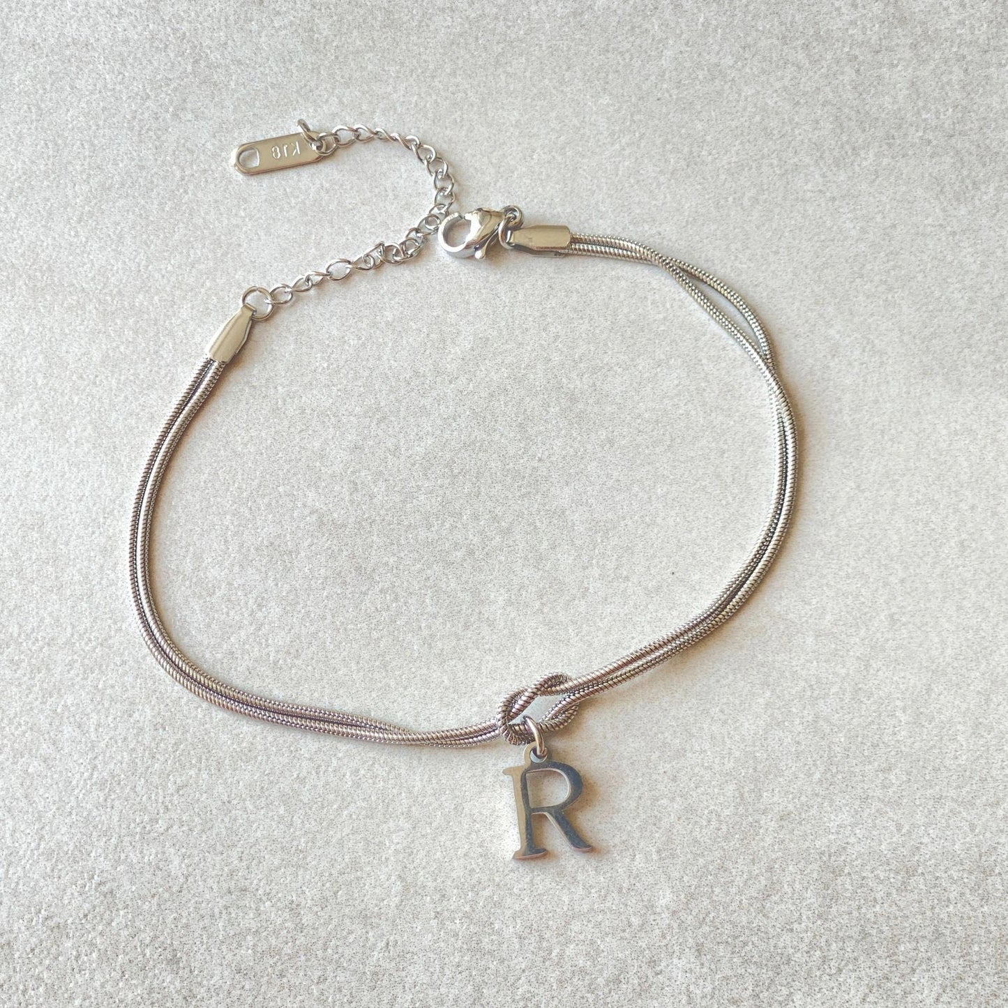 Personalised gold and silver love knot bracelets for couples, perfect as Valentine's Day gifts.