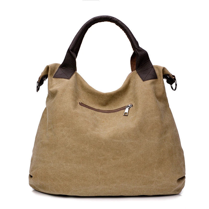 Stylish and versatile canvas shoulder bag with premium brass hardware and thoughtful interior organisation