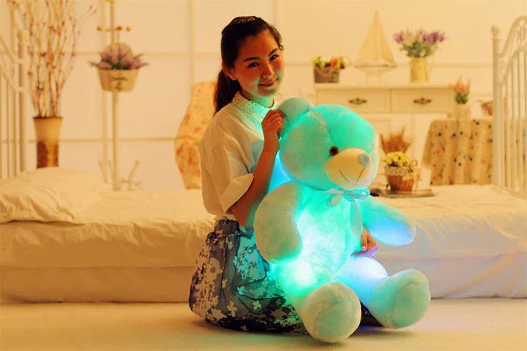 A soft and cuddly teddy bear plush toy with captivating color-changing LED lights, perfect for bringing wonder and delight to a child's room.