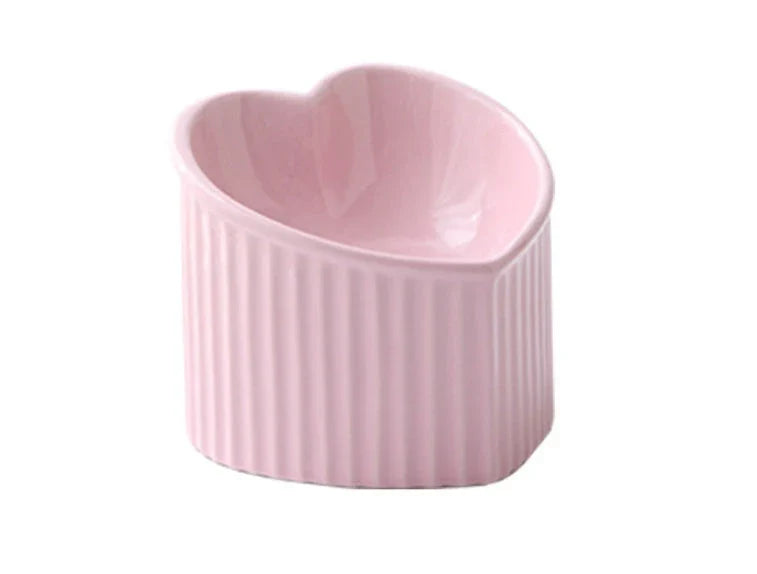 Elevated ceramic pet bowl with angled design for comfortable, natural feeding of cats and dogs