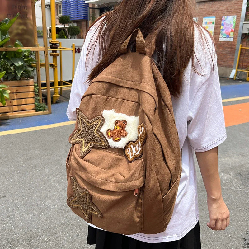A stylish and durable canvas backpack with geometric patterns, designed for female college students