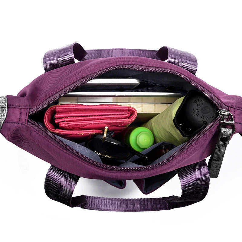 Versatile ladies shoulder bag with multiple carry options, numerous pockets, and durable Oxford fabric construction
