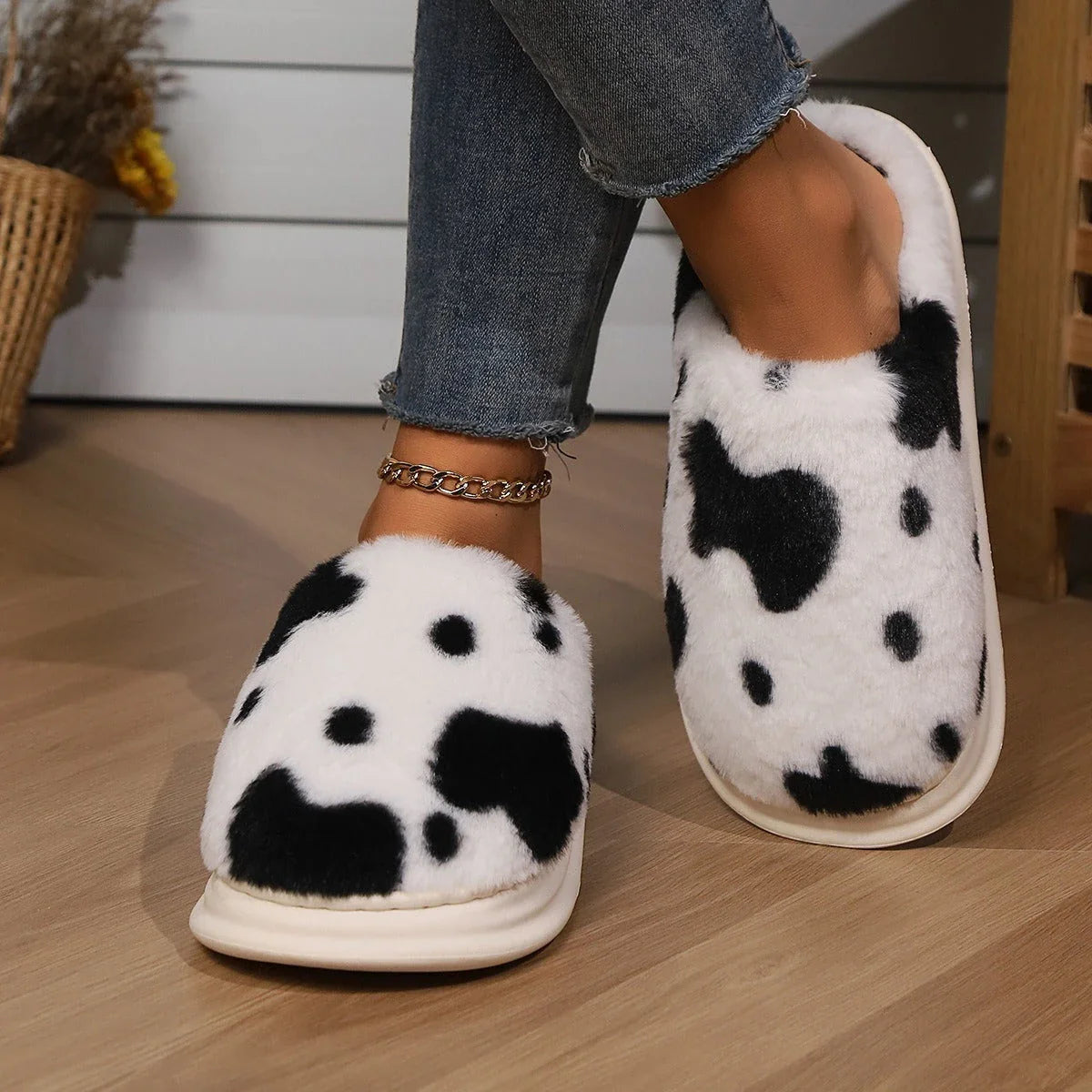 Cozy cow print plush slippers with a non-slip sole, perfect for indoor comfort and warmth