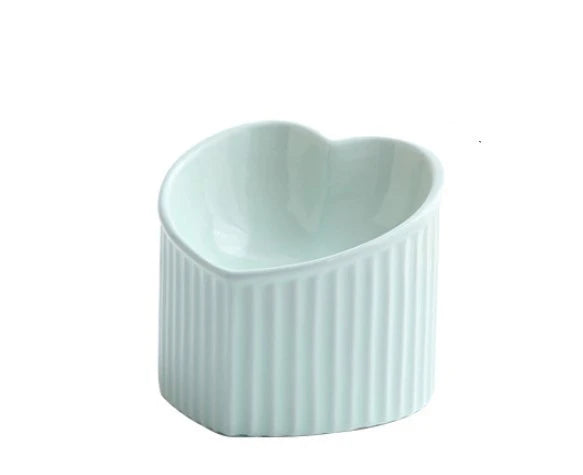 Elevated ceramic pet bowl with angled design for comfortable, natural feeding of cats and dogs