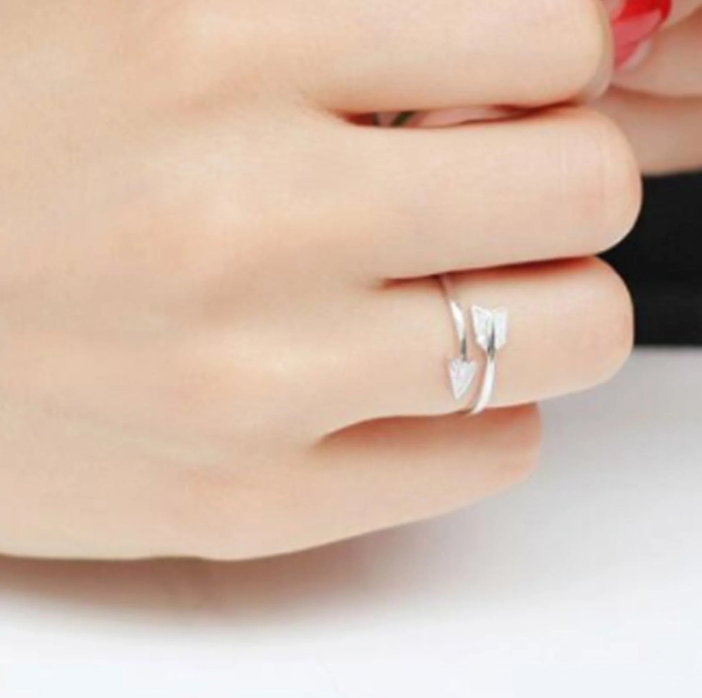Copper arrow-shaped ring with a sleek, polished finish and a touch of subtle shimmer for a sophisticated, modern look.
