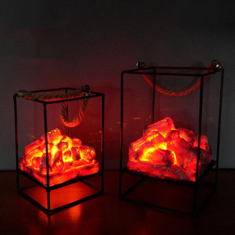 A charcoal-coloured fireplace lamp with a mesmerising LED flame effect, creating a cosy and inviting atmosphere in a living room.