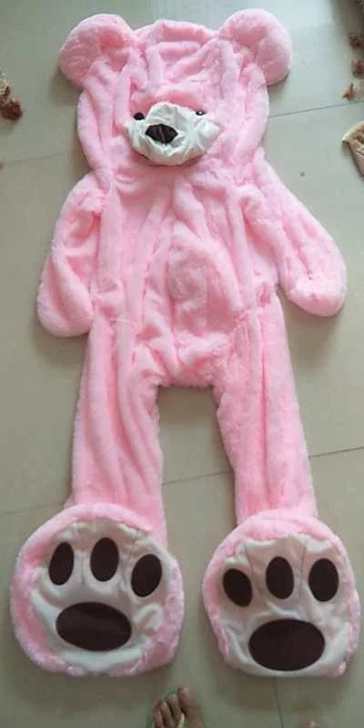 Colossal plush teddy bear in various sizes and colors, including light brown, dark brown, gray, white, pink, and purple