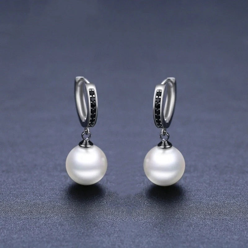 Trendy copper ball stud earrings with a minimalist design, showcasing a sleek and modern accessory for fashion-forward women