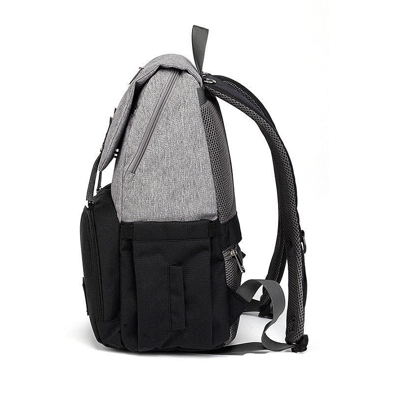 Versatile mummy bag with stroller hooks, side pockets, and zippered compartments for storing baby essentials