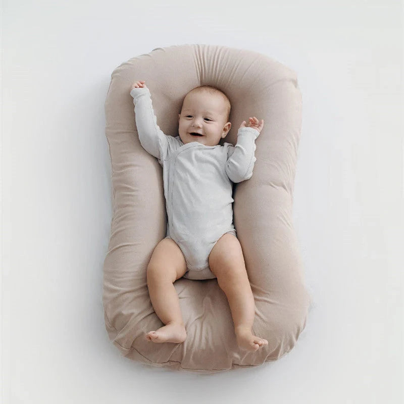 Portable baby nest crib with cotton cover for newborns, dimensions 75cm by 45cm