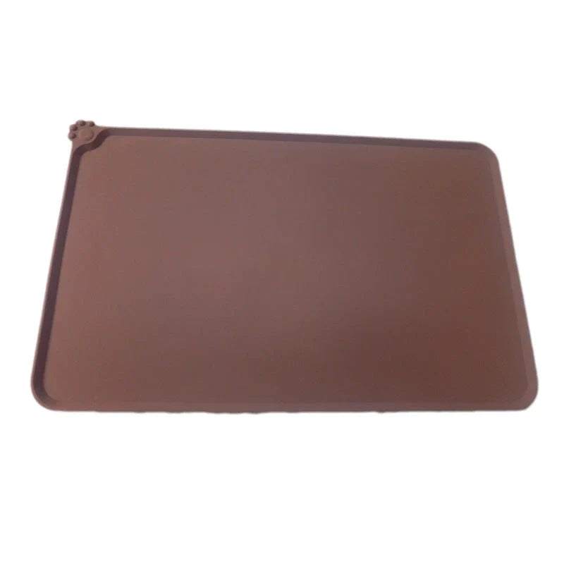 Spill-proof pet food mat made of durable silicone with non-slip base and raised edges to prevent messes