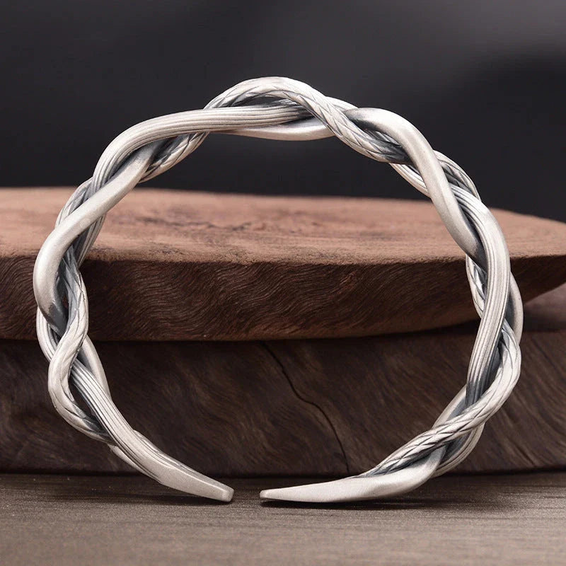 Elegant three-strand sterling silver bracelet with a unique twist design, perfect for couples and everyday wear