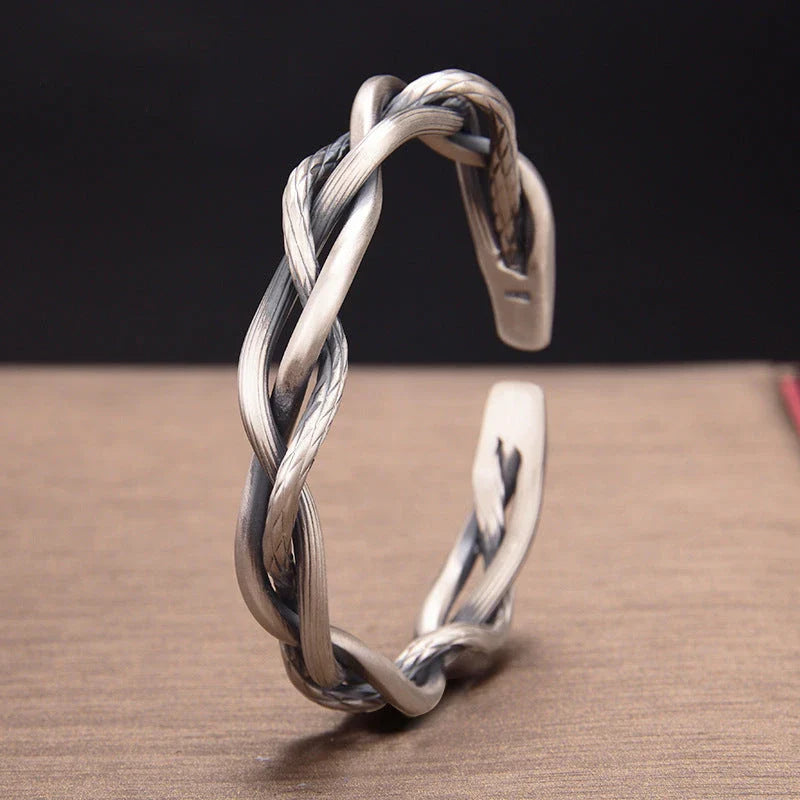 Elegant three-strand sterling silver bracelet with a unique twist design, perfect for couples and everyday wear