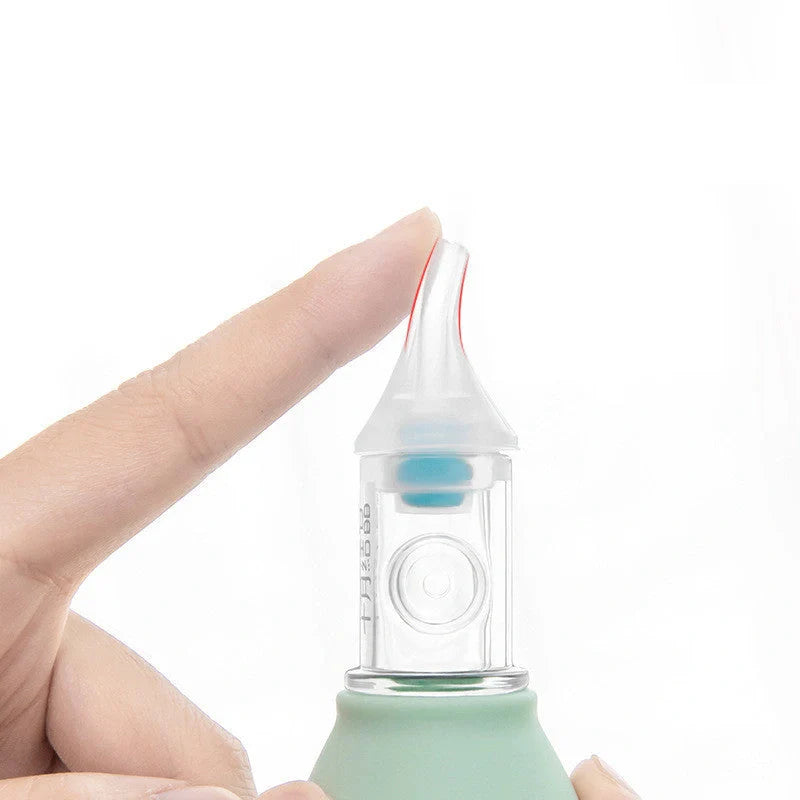 Infant silicone nasal aspirator pump in pink and green, designed for gentle cold relief