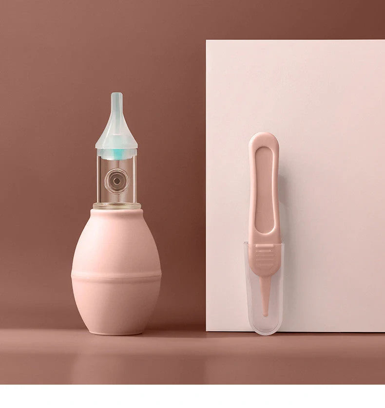 Infant silicone nasal aspirator pump in pink and green, designed for gentle cold relief