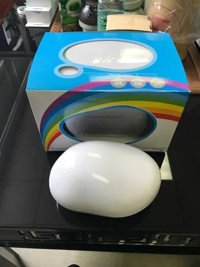 Enchanting rainbow projection lamp with vibrant multi-coloured LED lighting, creating a calming, relaxing atmosphere in the bedroom