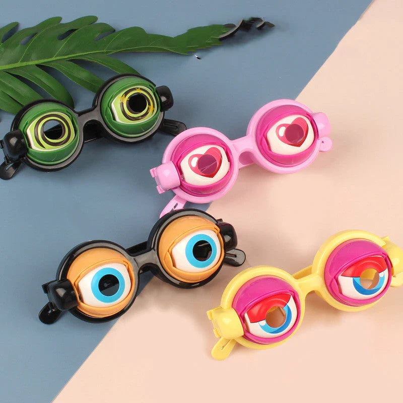 Quirky eyewear accessories in various colours, including yellow, pink, black, and black-green. Designed for kids' parties to encourage imagination and play.
