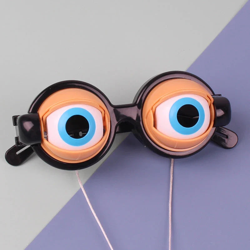 Quirky eyewear accessories in various colours, including yellow, pink, black, and black-green. Designed for kids' parties to encourage imagination and play.