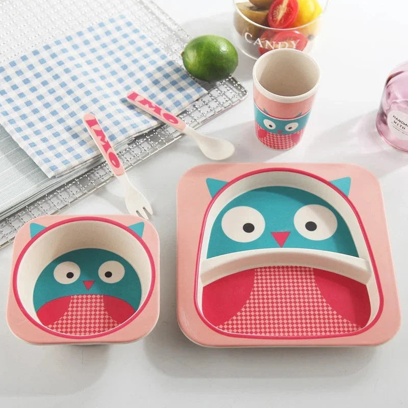 Five-piece bamboo fibre children's tableware set with plates, bowls, cups, spoons, and forks in various animal-themed designs