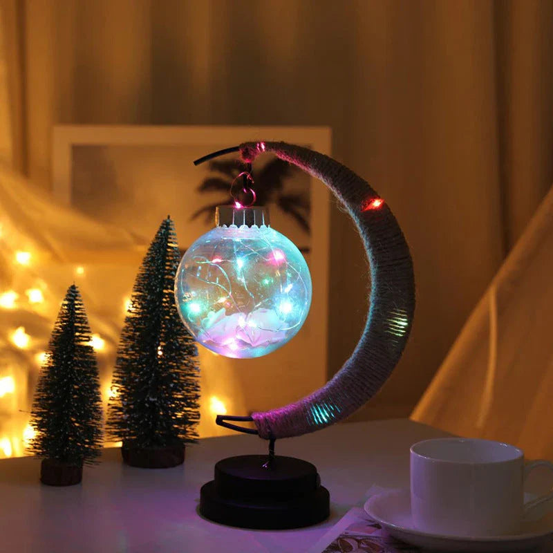 Lunar LED Lamp with crescent-shaped holder, emitting warm, soothing light in a variety of colour options