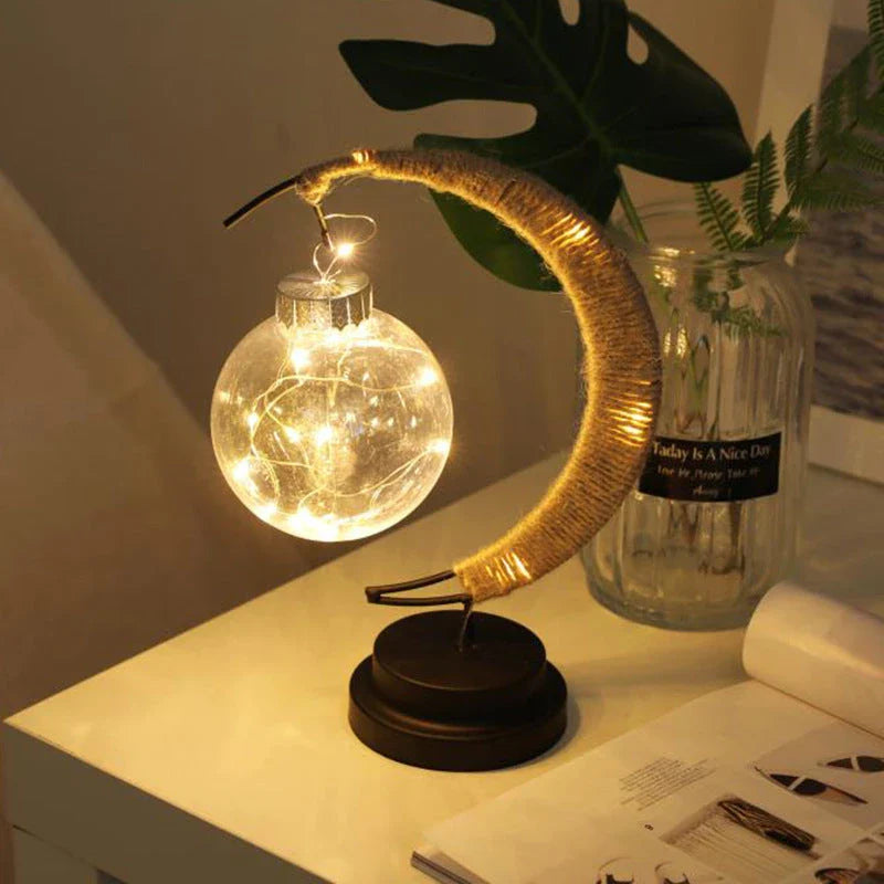 Lunar LED Lamp with crescent-shaped holder, emitting warm, soothing light in a variety of colour options