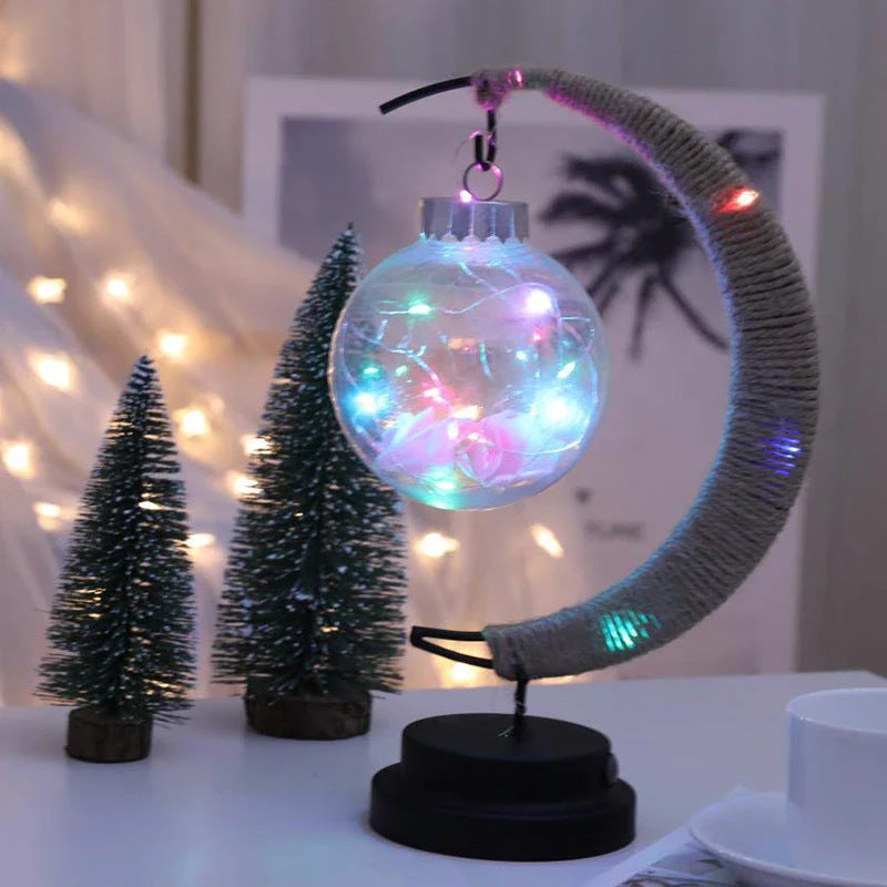 Lunar LED Lamp with crescent-shaped holder, emitting warm, soothing light in a variety of colour options