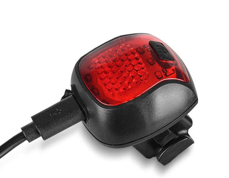 Rechargeable bicycle tail light with 5 adjustable lighting modes, made of durable ABS plastic for scratch and impact resistance.