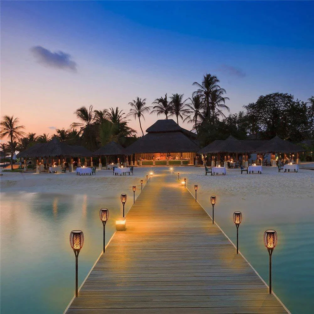 Elegant solar-powered garden lights illuminating a pathway in a lush British garden