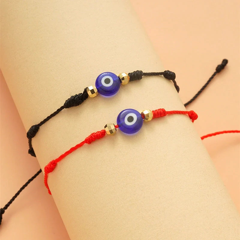 Braided evil eye bracelet set with 7-knot design for luck and protection, adjustable for all wrist sizes.