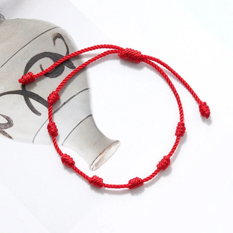 Braided evil eye bracelet set with 7-knot design for luck and protection, adjustable for all wrist sizes.