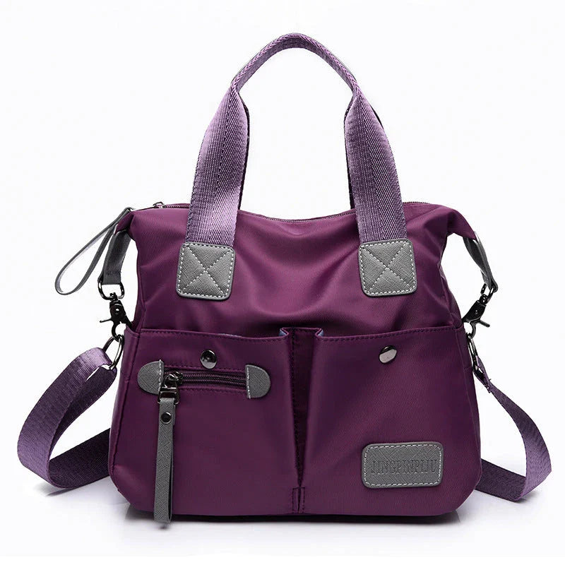Versatile ladies shoulder bag with multiple carry options, numerous pockets, and durable Oxford fabric construction