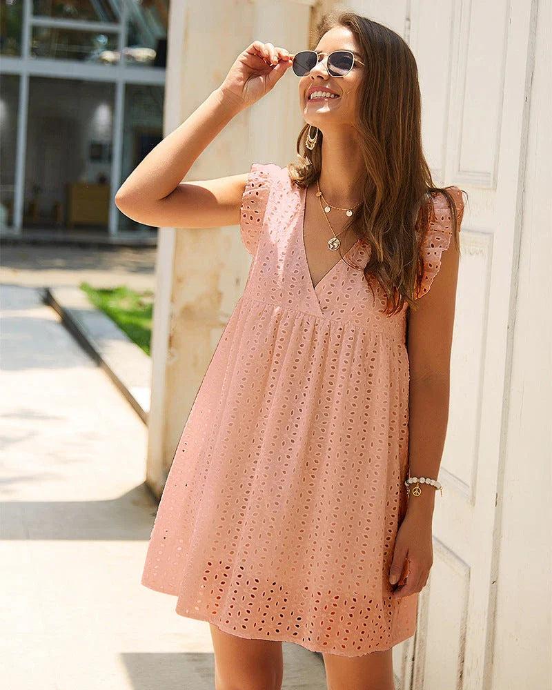 A stylish cotton mini dress with a v-neck and ruffled sleeves, perfect for summer days and nights.