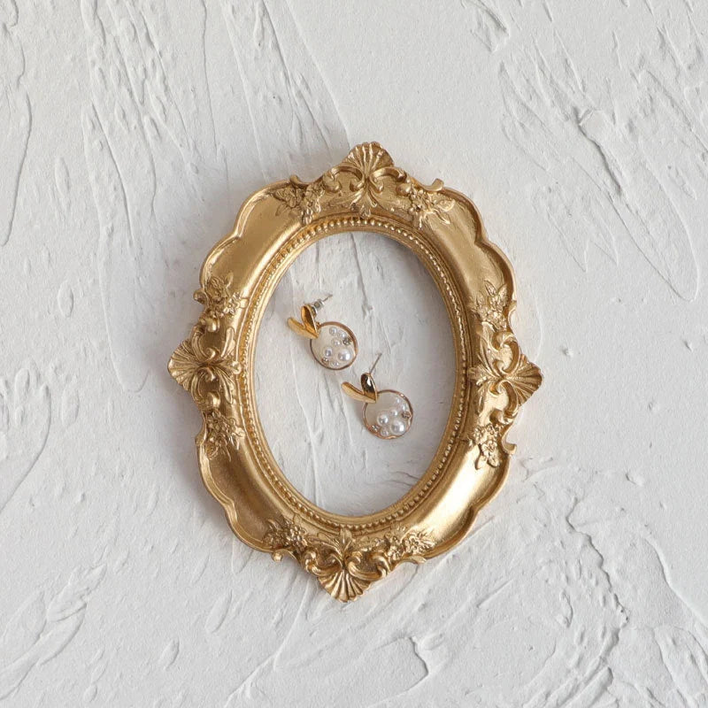 Golden Retro Photo Frame displaying jewellery and art in a Nordic-style resin design