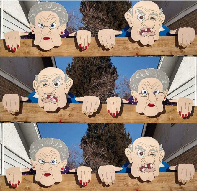 Quirky garden fence art decoration featuring an elderly couple peeking over a fence