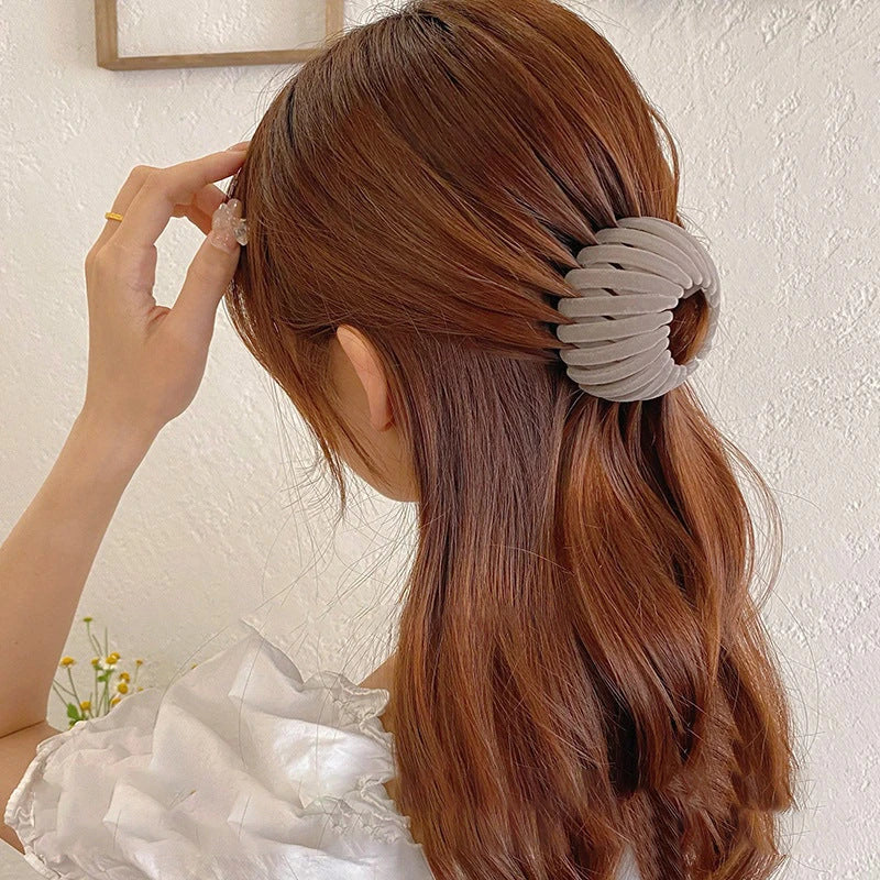 Elegant hair circle accessory with flexible design and teeth for creating stylish ponytails