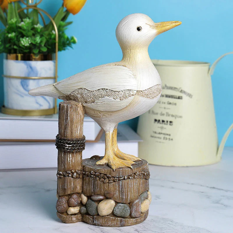 Resin seagull statue perched on a weathered wooden stump, bringing coastal charm to any indoor or outdoor space