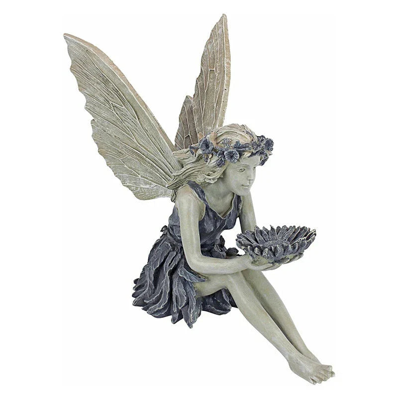 A beautiful resin fairy garden statue with a flower crown and petal skirt, holding a sunflower bowl to attract birds