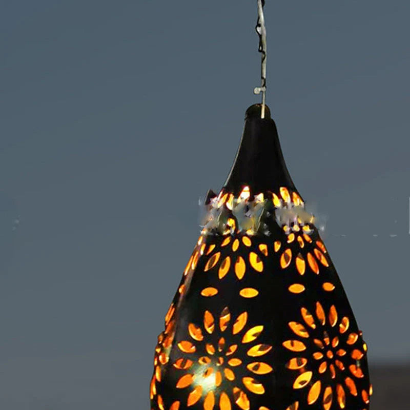 Solar-powered outdoor hanging lantern with flower-patterned shade, made of durable metal for long-lasting use in gardens, patios, and pathways.
